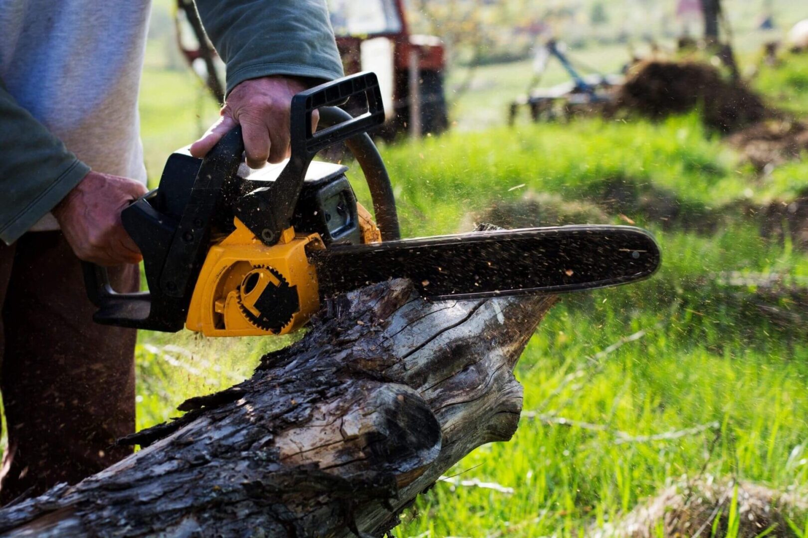 A person is holding on to a chain saw